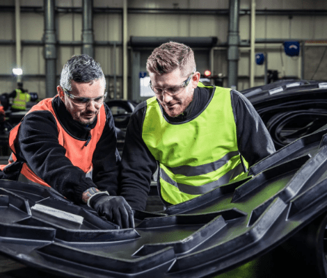 Smiley Monroe employees inspecting belt